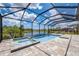 Gorgeous screened-in pool and spa with a tanning ledge, overlooking a tranquil lake and lush landscaping at 19912 Bridgetown Loop, Venice, FL 34293