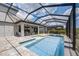 Inviting screened-in pool area with a jacuzzi and tanning ledge, perfect for enjoying outdoor living and entertaining at 19912 Bridgetown Loop, Venice, FL 34293