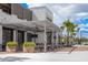 Charming restaurant patio with outdoor seating under a pergola, enhanced by lush planters and mature palm trees at 19912 Bridgetown Loop, Venice, FL 34293
