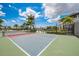 Active lifestyle with an outdoor Pickleball court surrounded by tropical palm trees and blue skies at 19912 Bridgetown Loop, Venice, FL 34293