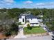 Expansive aerial view of a modern estate featuring lush landscaping and an inviting pool at 2177 Sunnyside Pl, Sarasota, FL 34239