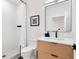 Modern bathroom featuring a minimalist design, walk-in shower, and natural wood vanity at 2177 Sunnyside Pl, Sarasota, FL 34239
