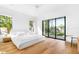 Bright bedroom with hardwood floors and an expansive window offering an inviting outdoor view at 2177 Sunnyside Pl, Sarasota, FL 34239