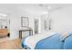 View of the bright bedroom with light hardwood floors, a console table, and the bathroom area at 2177 Sunnyside Pl, Sarasota, FL 34239