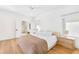 Large and bright bedroom with wood floors, recessed lighting, and an ensuite bath with shower at 2177 Sunnyside Pl, Sarasota, FL 34239