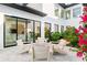 Charming courtyard features inviting patio seating and lush, manicured landscaping with flowering bougainvillea at 2177 Sunnyside Pl, Sarasota, FL 34239