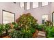 Lush courtyard with pink blossoms in raised planter at 2177 Sunnyside Pl, Sarasota, FL 34239