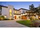 Elegant two-story home with stone accents, a wood garage door and inviting curb appeal at 2177 Sunnyside Pl, Sarasota, FL 34239