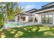 Lush backyard features pool, outdoor kitchen, and covered porch, perfect for luxurious outdoor living and entertaining at 2177 Sunnyside Pl, Sarasota, FL 34239