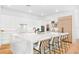 Gourmet kitchen featuring white cabinets, a large island and a modern appliance package at 2177 Sunnyside Pl, Sarasota, FL 34239