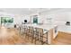 Open-concept kitchen featuring a large island with seating and modern white cabinets at 2177 Sunnyside Pl, Sarasota, FL 34239