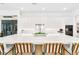 Stylish kitchen featuring an oversized island with seating and sleek white cabinetry at 2177 Sunnyside Pl, Sarasota, FL 34239