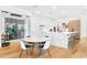 Open-concept kitchen and dining area with modern furnishings, a wine fridge, and stylish decor at 2177 Sunnyside Pl, Sarasota, FL 34239