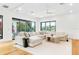 Spacious living room features a large sectional sofa, plush rug, and sliding doors to the outdoors at 2177 Sunnyside Pl, Sarasota, FL 34239