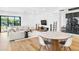 Bright and open living space with hardwood floors, modern furniture, and dining area at 2177 Sunnyside Pl, Sarasota, FL 34239