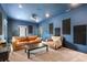 Home media room with a projector, plush seating, acoustic panels and view from the window at 2177 Sunnyside Pl, Sarasota, FL 34239