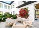 An outdoor patio showcasing modern furniture and flourishing landscaping in a tranquil setting at 2177 Sunnyside Pl, Sarasota, FL 34239