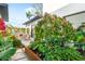 Lush patio with outdoor seating and colorful flowers at 2177 Sunnyside Pl, Sarasota, FL 34239