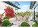 Inviting patio with comfortable seating, vibrant flowers, and tranquil outdoor views at 2177 Sunnyside Pl, Sarasota, FL 34239