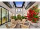 Outdoor patio with four chairs surrounded by lush landscaping and bougainvillea at 2177 Sunnyside Pl, Sarasota, FL 34239