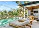 Resort-style pool and spa with sun loungers and an outdoor kitchen for luxurious relaxation and entertaining at 2177 Sunnyside Pl, Sarasota, FL 34239
