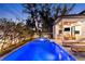 Sparkling backyard pool and spa with outdoor kitchen for entertaining, and lush landscaping at 2177 Sunnyside Pl, Sarasota, FL 34239