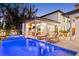 Stunning backyard pool and spa with outdoor kitchen, inviting lounge chairs, and access to the home at 2177 Sunnyside Pl, Sarasota, FL 34239