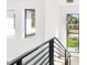 Bright staircase with minimalist design and views of the neighborhood at 2177 Sunnyside Pl, Sarasota, FL 34239