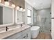 Contemporary bathroom featuring a double vanity, soaking tub, glass enclosed shower, and modern fixtures at 2375 Saybrook Ave, North Port, FL 34286