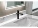 Modern bathroom featuring a sleek black faucet, stylish tile backsplash, and marble countertop at 2375 Saybrook Ave, North Port, FL 34286
