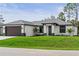 Charming single-Gathering home with a well-maintained lawn, elegant exterior, and inviting entrance at 2375 Saybrook Ave, North Port, FL 34286