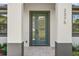 Close-up of a modern home's entrance, showcasing the stylish door, address numbers, and elegant stonework at 2375 Saybrook Ave, North Port, FL 34286