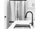 Modern kitchen with black faucet, stainless steel refrigerator and white countertop at 2375 Saybrook Ave, North Port, FL 34286