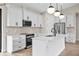 Bright kitchen featuring white cabinets, stainless steel appliances, a center island, and modern pendant lighting at 2375 Saybrook Ave, North Port, FL 34286