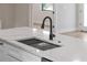 A modern sink with a silver drying rack on a white countertop, with wood floors at 2375 Saybrook Ave, North Port, FL 34286