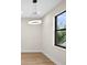 A versatile room featuring a modern light fixture, and a large window at 2375 Saybrook Ave, North Port, FL 34286
