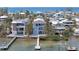 Aerial view of a stunning waterfront property with a pool, private dock, and beautifully landscaped grounds at 2407 Avenue A, Bradenton Beach, FL 34217