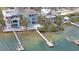 Waterfront homes boast private docks, pools, and lush landscaping along a tranquil bay at 2407 Avenue A, Bradenton Beach, FL 34217