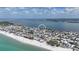 Aerial view of a charming coastal town with a beautiful beach, waterfront homes, and stunning bay views at 2407 Avenue A, Bradenton Beach, FL 34217