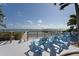 Waterfront deck with comfortable seating, a wooden railing, and breathtaking views of the bay at 2407 Avenue A, Bradenton Beach, FL 34217