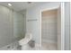 Well-lit bathroom with a glass shower door and wire shelving at 2407 Avenue A, Bradenton Beach, FL 34217