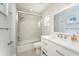 Renovated bathroom with glass shower door, sleek white cabinets, and modern fixtures at 2407 Avenue A, Bradenton Beach, FL 34217