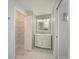Bathroom with a white vanity and storage shelves at 2407 Avenue A, Bradenton Beach, FL 34217