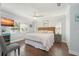 Bright bedroom with a woven headboard, wood floors, and a ceiling fan at 2407 Avenue A, Bradenton Beach, FL 34217