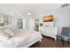 Spacious primary suite with ensuite bathroom, modern ceiling fan, and a large dresser with a wall-mounted TV at 2407 Avenue A, Bradenton Beach, FL 34217