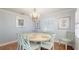 Elegant dining room with chandelier, round table for six, and bright, natural light at 2407 Avenue A, Bradenton Beach, FL 34217