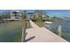 Private dock with weathered wood planks along the channel with a ladder and cleaning station at 2407 Avenue A, Bradenton Beach, FL 34217