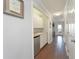 Hallway with built-in wet bar featuring a sink, mini-fridge, and cabinetry for convenient entertaining and storage at 2407 Avenue A, Bradenton Beach, FL 34217