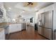 Modern kitchen with stainless steel appliances, breakfast bar, and wood flooring at 2407 Avenue A, Bradenton Beach, FL 34217