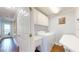 Functional laundry room with full-size washer, dryer, utility sink, ample storage, and easy outdoor access at 2407 Avenue A, Bradenton Beach, FL 34217
